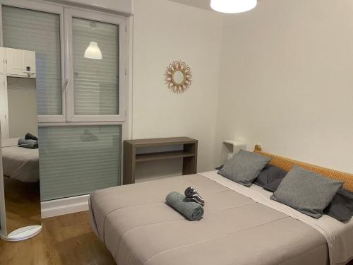 a bedroom with two beds and a window at appartement mérignac avec parking in Mérignac