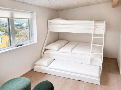 a white bunk bed in a room with a window at Hvanngarðs Smáttan by Stóra in Dalur