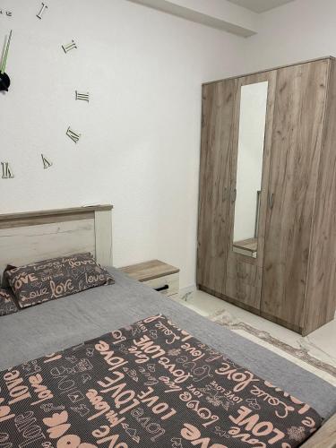 a bedroom with a bed and a mirror on the wall at Piad Apartman in Bar