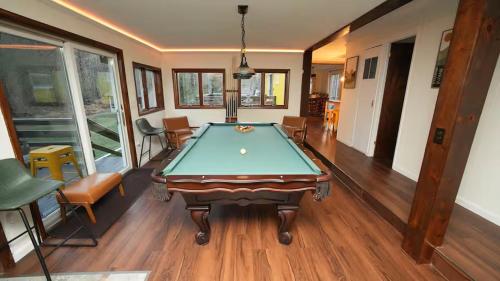 a pool table in the middle of a room at Nemandua Catskills: Hot Tub+Fire Pit+Pool Table+EV in Lanesville