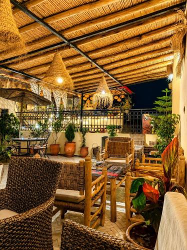 a patio with a table and chairs and plants at Riad Tafoukt Palace in Fez