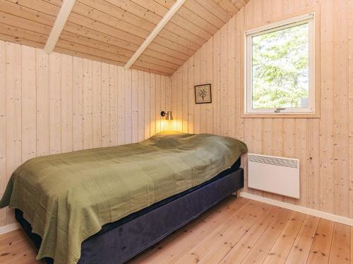 a bedroom with a bed in a room with a window at 4 star holiday home in Græsted in Græsted