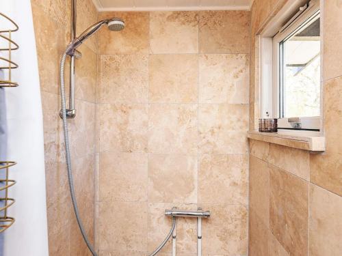 a bathroom with a shower with a shower head at 4 star holiday home in Græsted in Græsted