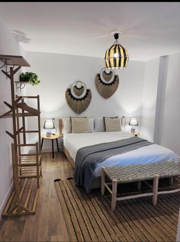 a bedroom with a bed and a wooden ladder at Raíces de Canillas Holiday Apartments in Canillas de Aceituno