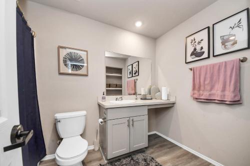 a bathroom with a toilet and a sink at Modern Living, Close to Everything in Houston