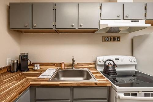 a kitchen with a sink and a stove at Spacious King Historic Art Deco Studio in Anchorage