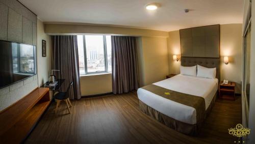 a hotel room with a bed and a television at Hotel Boutique Candamo in Lima
