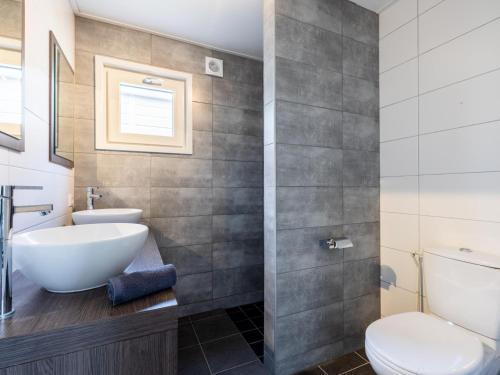 a bathroom with a sink and a toilet at Sluisje 55 in Kuinre