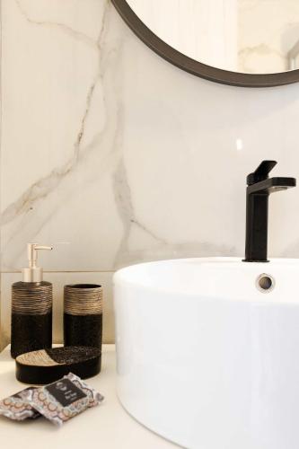 a bathroom counter with a sink and a mirror at Domus Villa in Ermioni