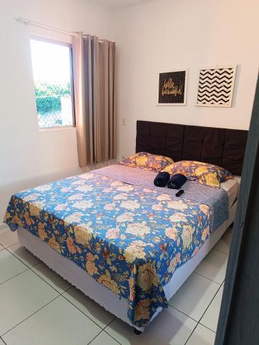 a bedroom with a bed with shoes on it at Ap Completo na zona Nobre com 3 quartos, sendo 1 suíte in Teresina