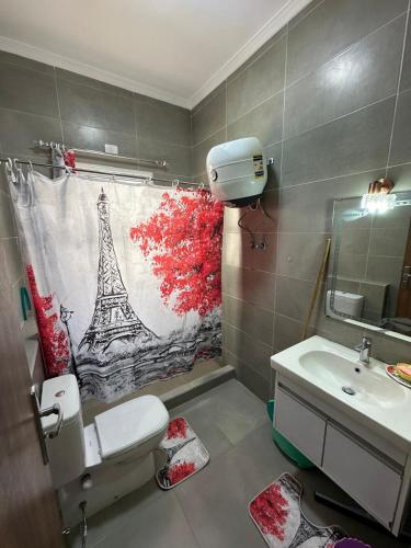 a bathroom with a toilet and a sink and a towel at AMWAj in El Alamein