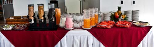 a red and white table with food and drinks at Hotel San José Plaza in Bucaramanga