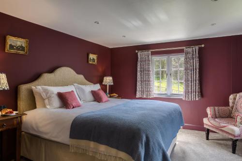 a bedroom with a large bed and a window at Roft Bank Cottage in Oswestry