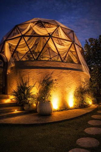 a building with a dome on a wall with lights at Cannatel Exclusive Hotel in Armenia