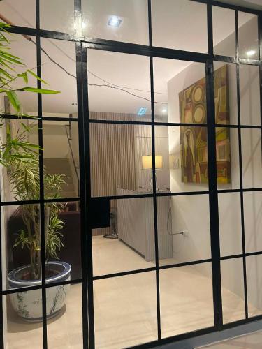 a glass door with a potted plant in a room at Residencia de Azucena in Tacloban