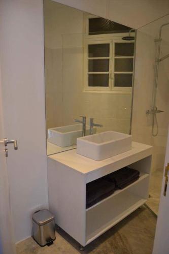 a bathroom with a sink and a mirror at Charming Apartment 101 in Funchal