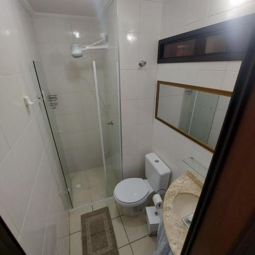 a bathroom with a shower and a toilet and a sink at Gourmet space in São Paulo