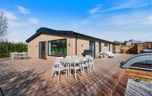 a patio with a table and chairs on a deck at Beautiful Home In Ejstrupholm in Krejbjerg
