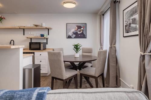 a room with a table and chairs and a kitchen at Inlet View Luxe -King Suite - Downtown Anchorage in Anchorage