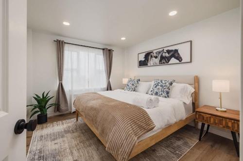 a bedroom with a large bed and a window at Inlet View Luxe -King Suite - Downtown Anchorage in Anchorage
