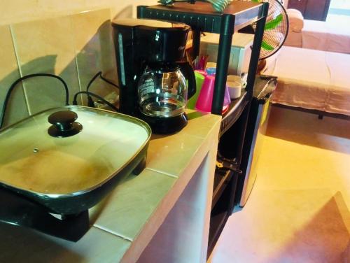 a kitchen counter with a sink and a coffee maker at Casa NAU Mazunte in Mazunte