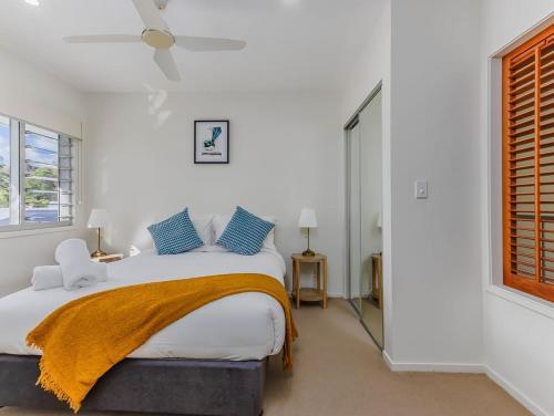 a bedroom with a bed and a window at Macadamia Ocean Escape in Pottsville