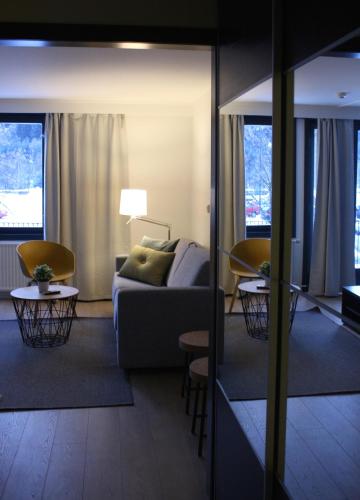 a living room with a couch and a table and chairs at Trudvang Apartment Hotel in Rena