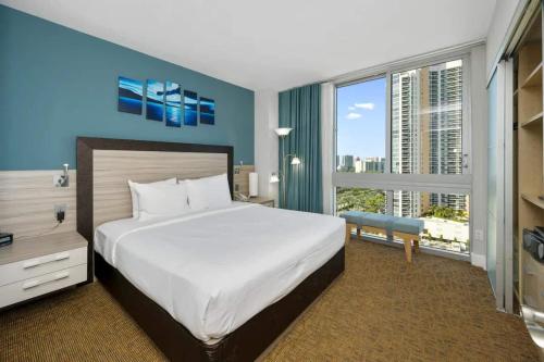 a bedroom with a large bed and a large window at Oceanview Apt Marenas Resort, Direct Beach Access! in Sunny Isles Beach