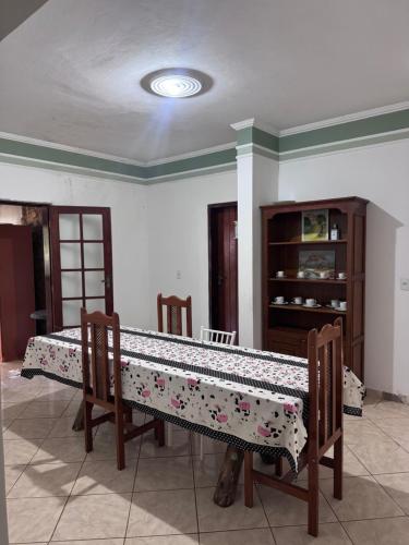 a living room with a table with a cloth on it at Quarto privativo com suite para 1 pessoa in Campinas