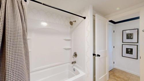 a white bathroom with a tub and a shower at 240 Captains Quarters in Hilton Head Island