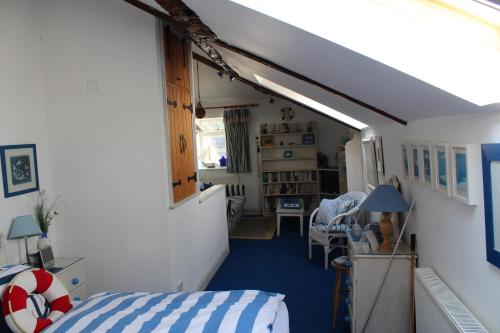 a room with a bedroom with a bed and a hallway at Clayton Wickham Farmhouse in Hurstpierpoint