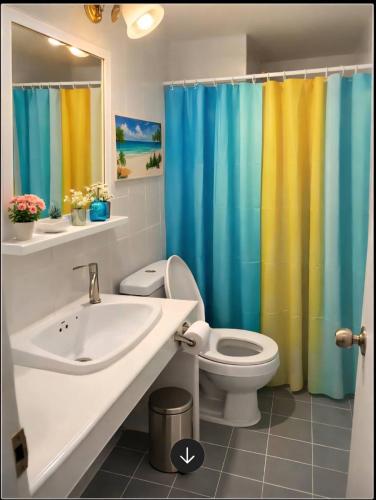 a bathroom with a sink and a toilet and a shower curtain at Ally home 14 08 in Ban Bang Phang