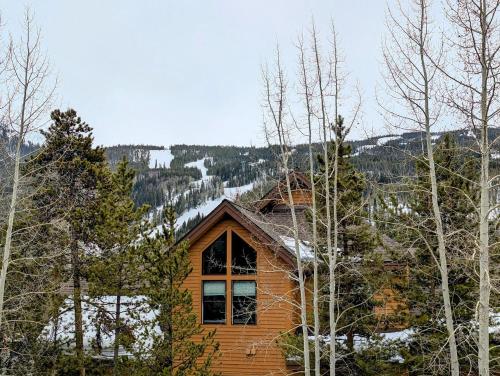 a log cabin in the woods with snow at Gateway Lodge 5030 by SummitCove Lodging in Colorado in Keystone