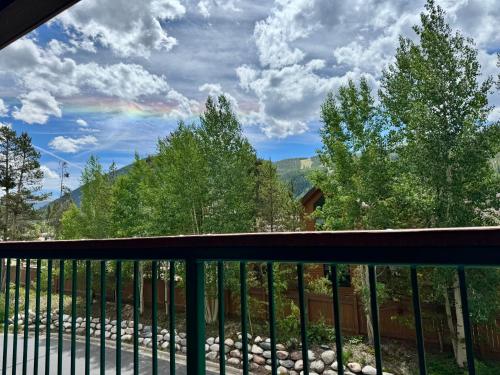 a view from a balcony with a rainbow at Gateway Lodge 5030 by SummitCove Lodging in Colorado in Keystone