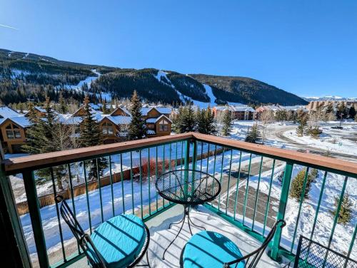 a balcony with two chairs and a swimming pool at Gateway Lodge 5099 by SummitCove Lodging in Colorado in Keystone