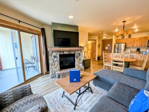 a living room with a couch and a fireplace at Expedition Station 8622 by SummitCove Lodging in Colorado in Keystone