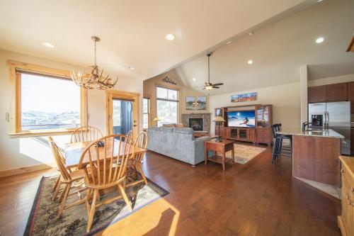 a kitchen and living room with a table and chairs at Frey Gulch 46 by SummitCove Lodging in Colorado in Keystone