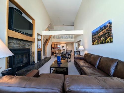 a living room with a couch and a fireplace at Pines 2129 by SummitCove Lodging in Colorado in Keystone