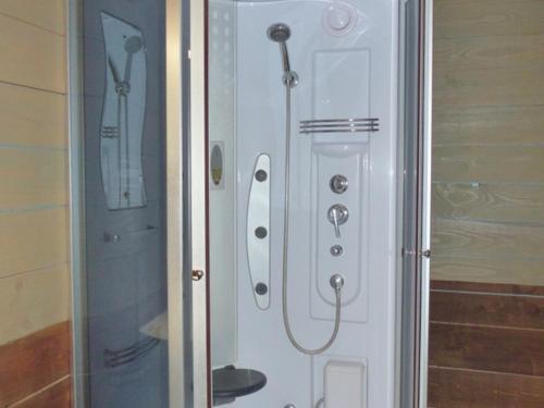 a shower stall with a shower head and a shower at Éco-gîte rénové avec wifi près de Vichy - FR-1-489-290 in Bransat