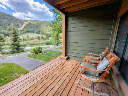 a rocking chair sitting on a porch of a house at Tenderfoot Lodge 2613 by SummitCove Lodging in Colorado in Keystone