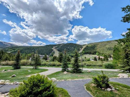 a view of a road with mountains in the background at Tenderfoot Lodge 2613 by SummitCove Lodging in Colorado in Keystone