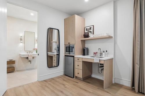 a small bathroom with a sink and a mirror at Casa Iglesia in Santa Barbara
