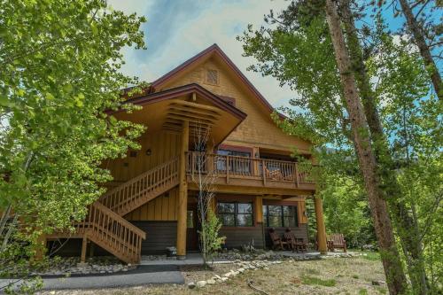 a log home with a wrap around deck at Trappers Crossing 8753 by SummitCove Lodging in Colorado in Keystone