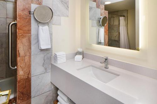 a bathroom with a sink and a mirror at Crowne Plaza Hotel Monterrey by IHG in Monterrey
