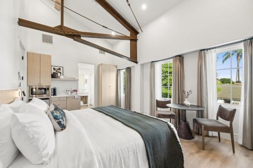 a bedroom with a bed and a table with chairs at Casa Iglesia in Santa Barbara