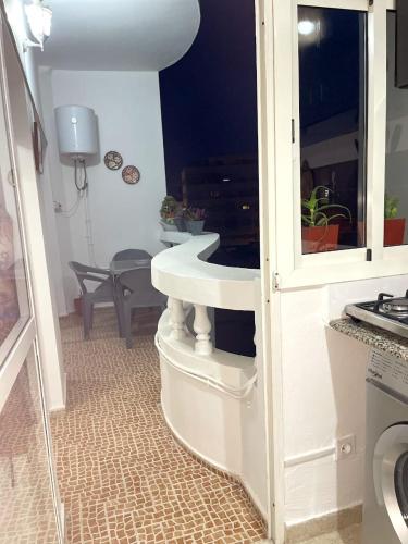 a kitchen with a white sink in a room at Cozy apartment center, Larache in Larache