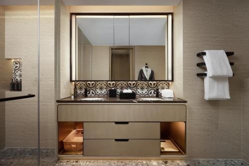 a bathroom with a sink and a mirror at Haig Court - Welcome Drink & Welcome Fruit in Shanghai
