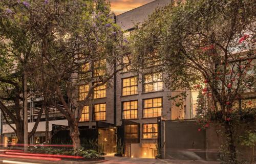 a building with trees in front of it at Kukun Edition El Angel in Mexico City