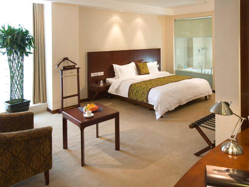a hotel room with a bed and a table at Wanshang Garden Hotel in Beijing