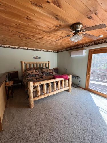 a bedroom with a bed with a wooden ceiling at Woodland Hideaway in Naples